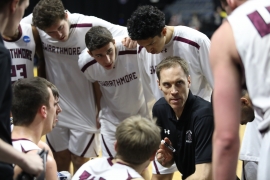 Basketball coach speaking with players